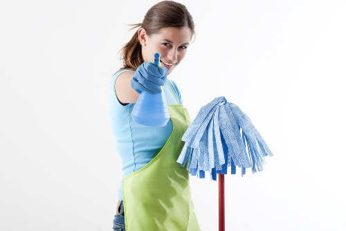 Technician handling carpet cleaning equipment with attention to manual handling and safety