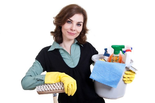 Team maintaining safe, tidy carpet cleaning work area with equipment and warning signs